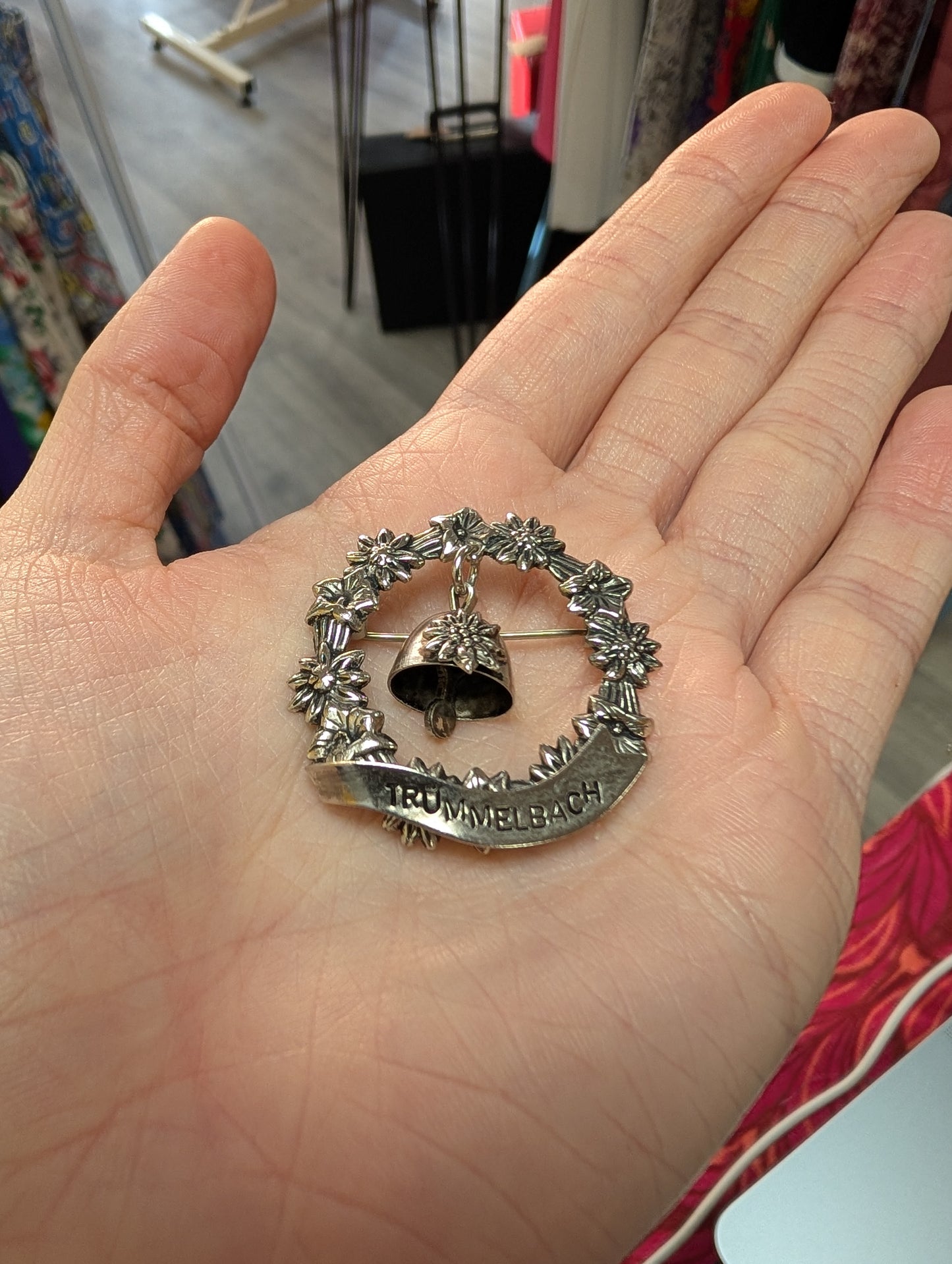 Trümmelbach floral souvenir brooch with bell
