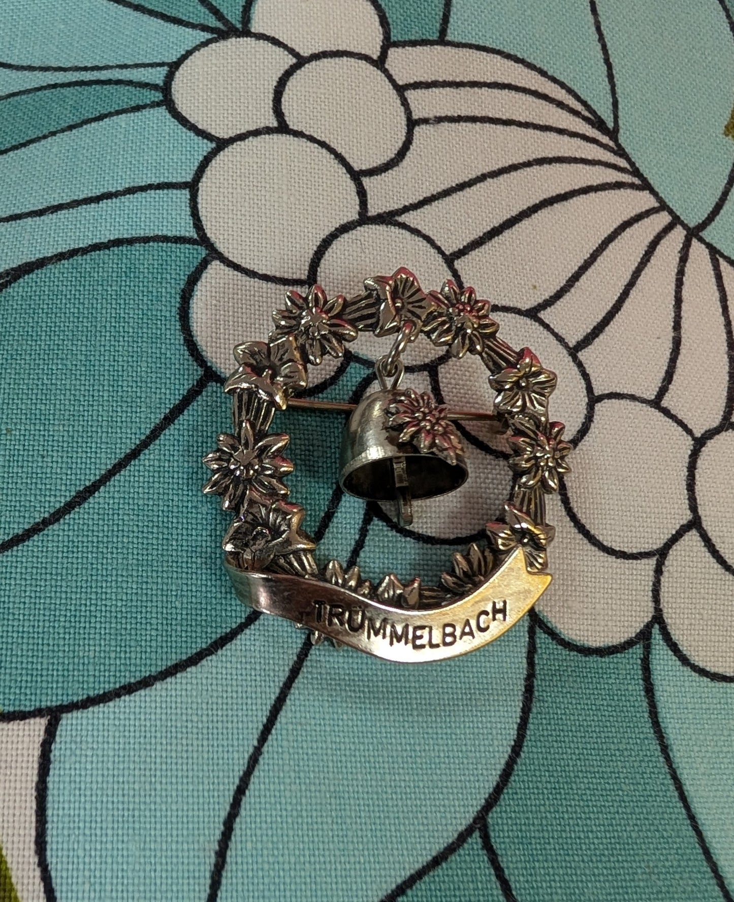 Trümmelbach floral souvenir brooch with bell